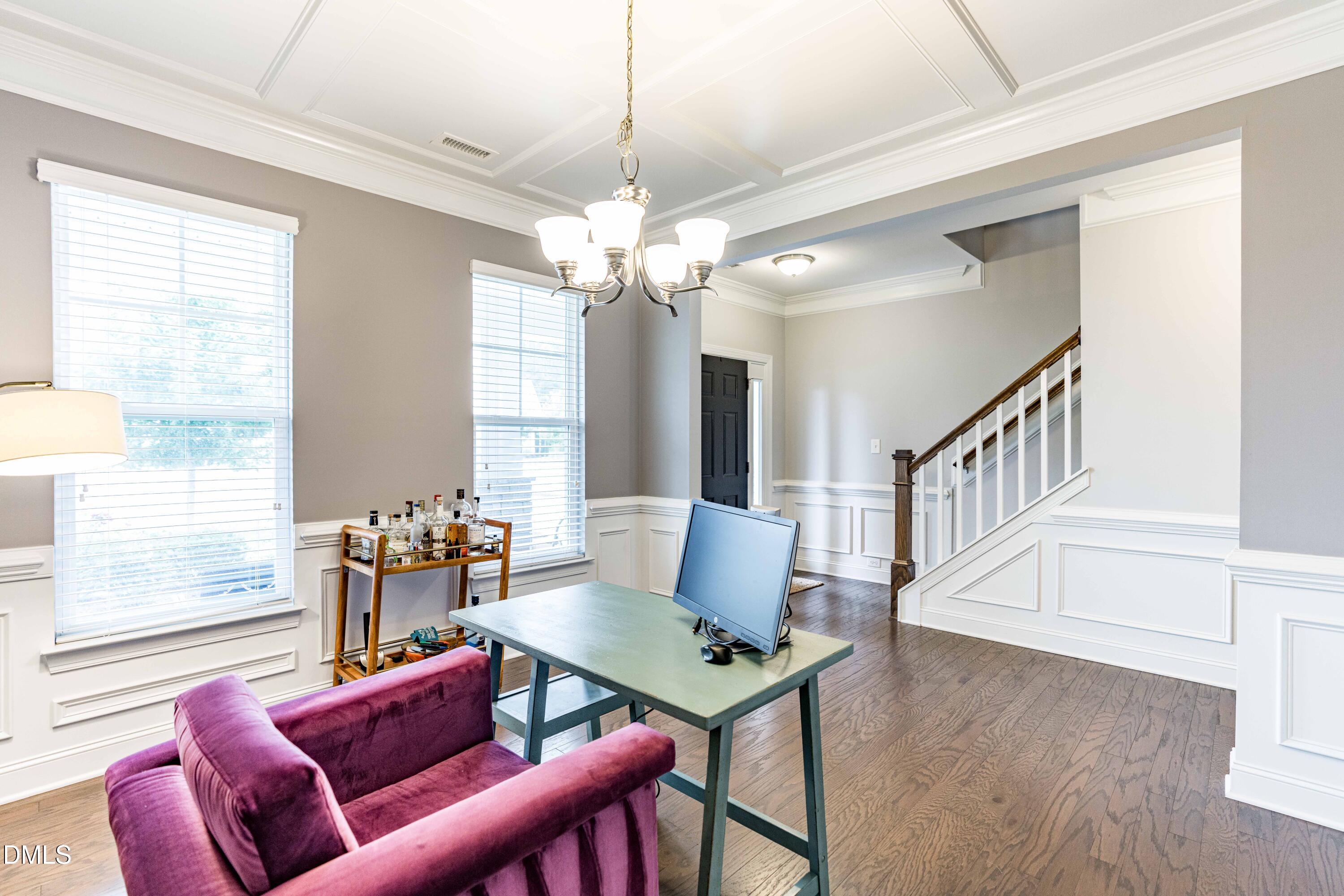 5405 Weathered Rock Court Knightdale, NC 27545 - Photo 12 of 36 a living room with furniture a table and a chandelier