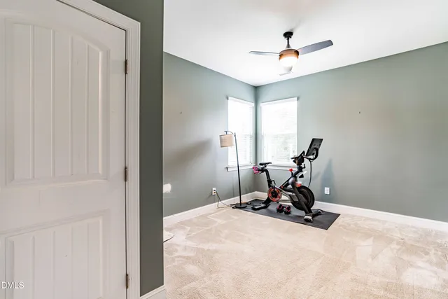 a view of a room with a window and gym cycle