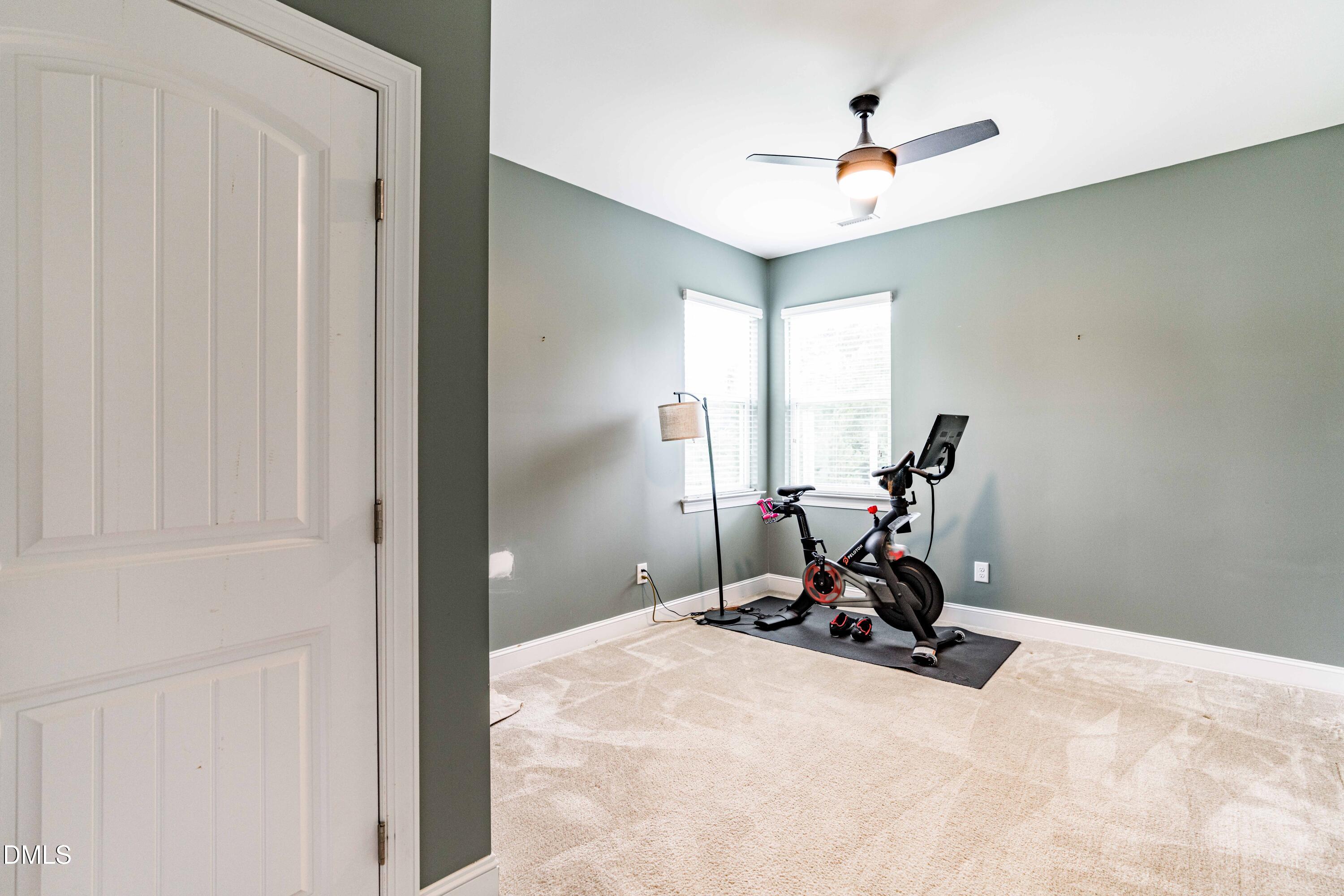 5405 Weathered Rock Court Knightdale, NC 27545 - Photo 14 of 36 a view of a room with a window and gym cycle