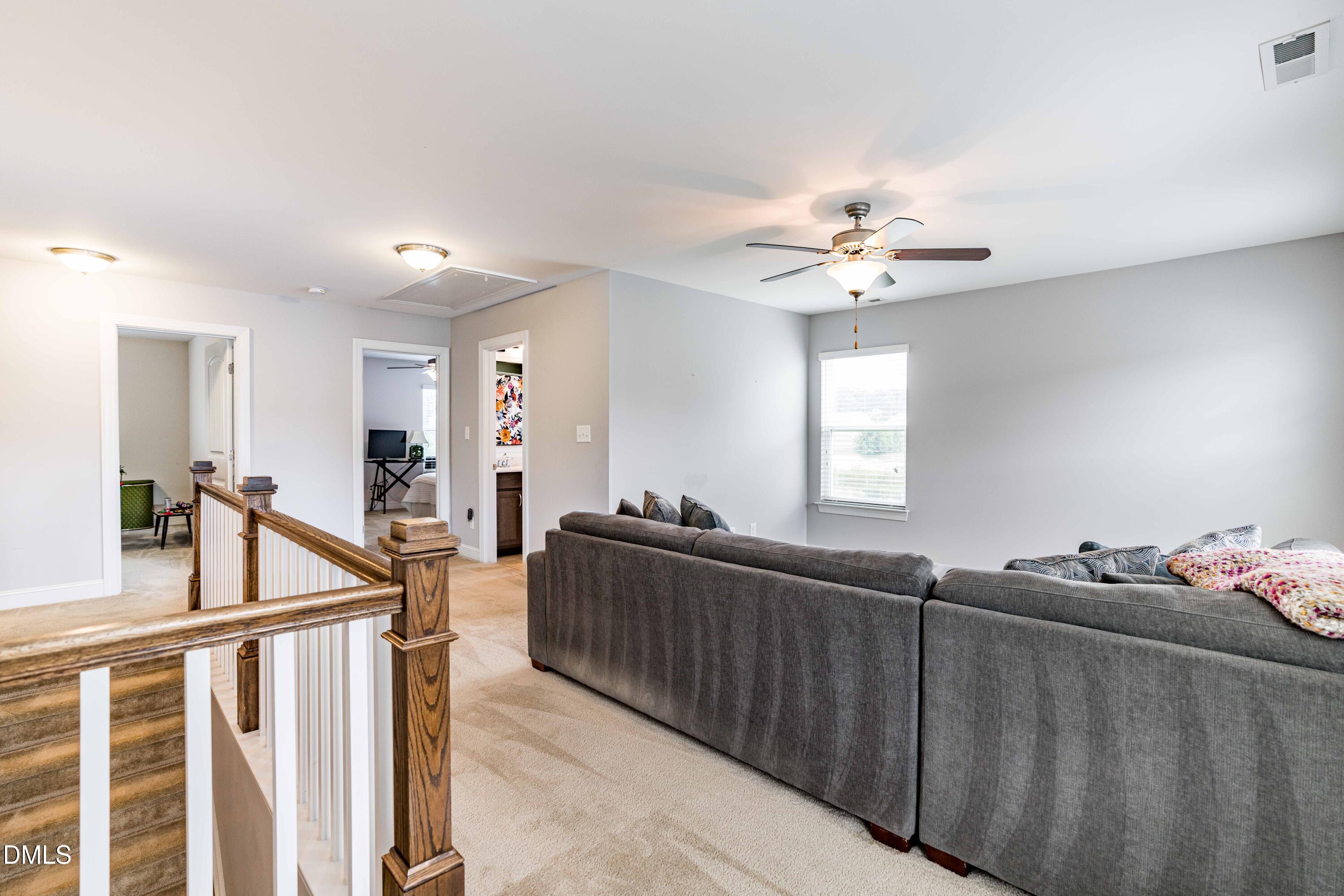 5405 Weathered Rock Court Knightdale, NC 27545 - Photo 19 of 36 a living room with furniture a chandelier fan and a window