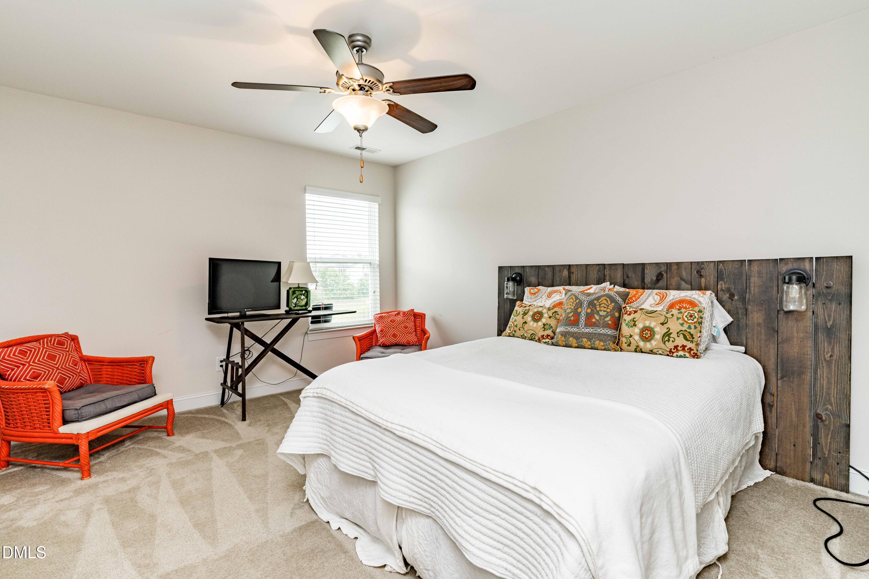 5405 Weathered Rock Court Knightdale, NC 27545 - Photo 23 of 36 a bedroom with bed and a chandelier