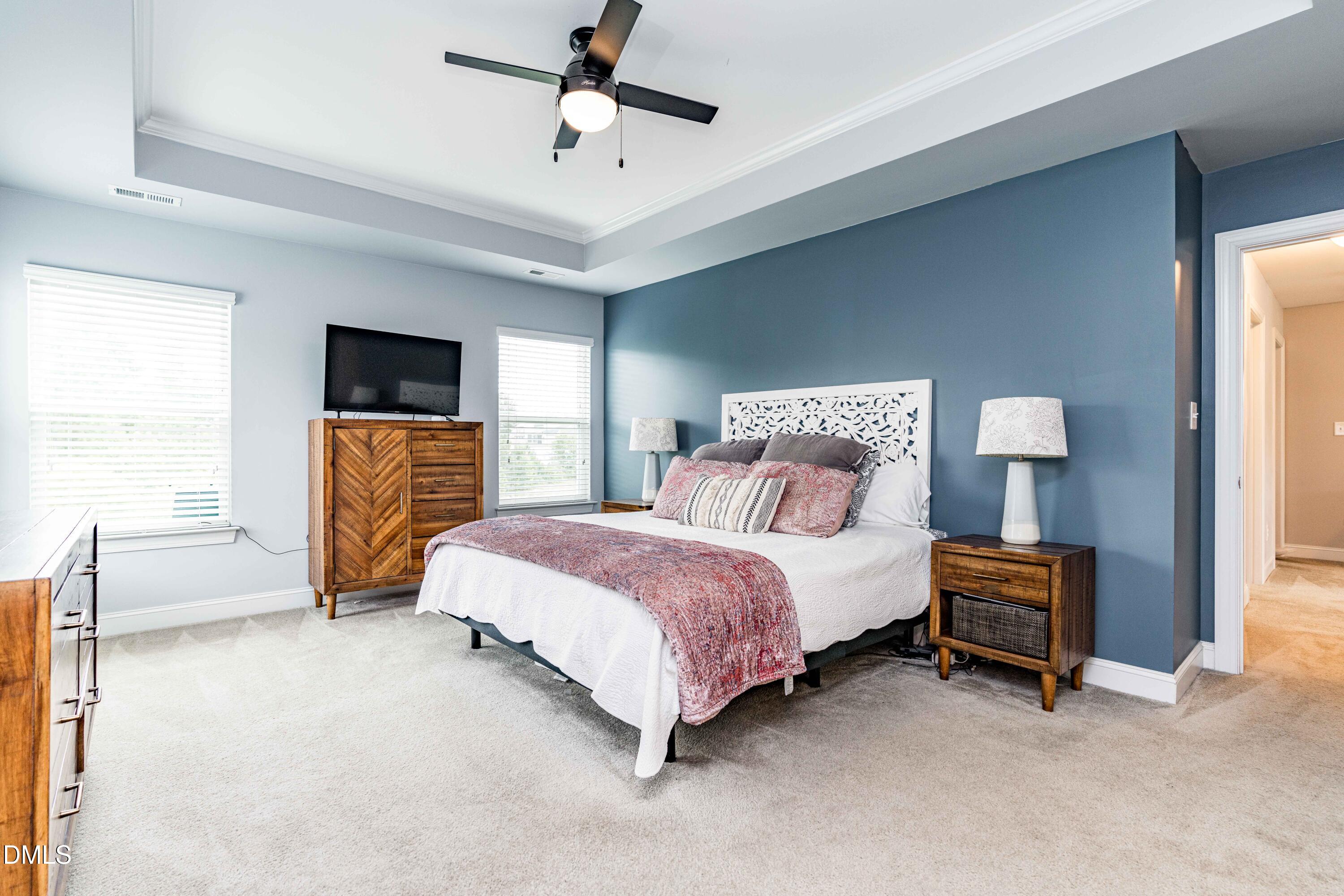 5405 Weathered Rock Court Knightdale, NC 27545 - Photo 25 of 36 a bedroom with a bed and a tv