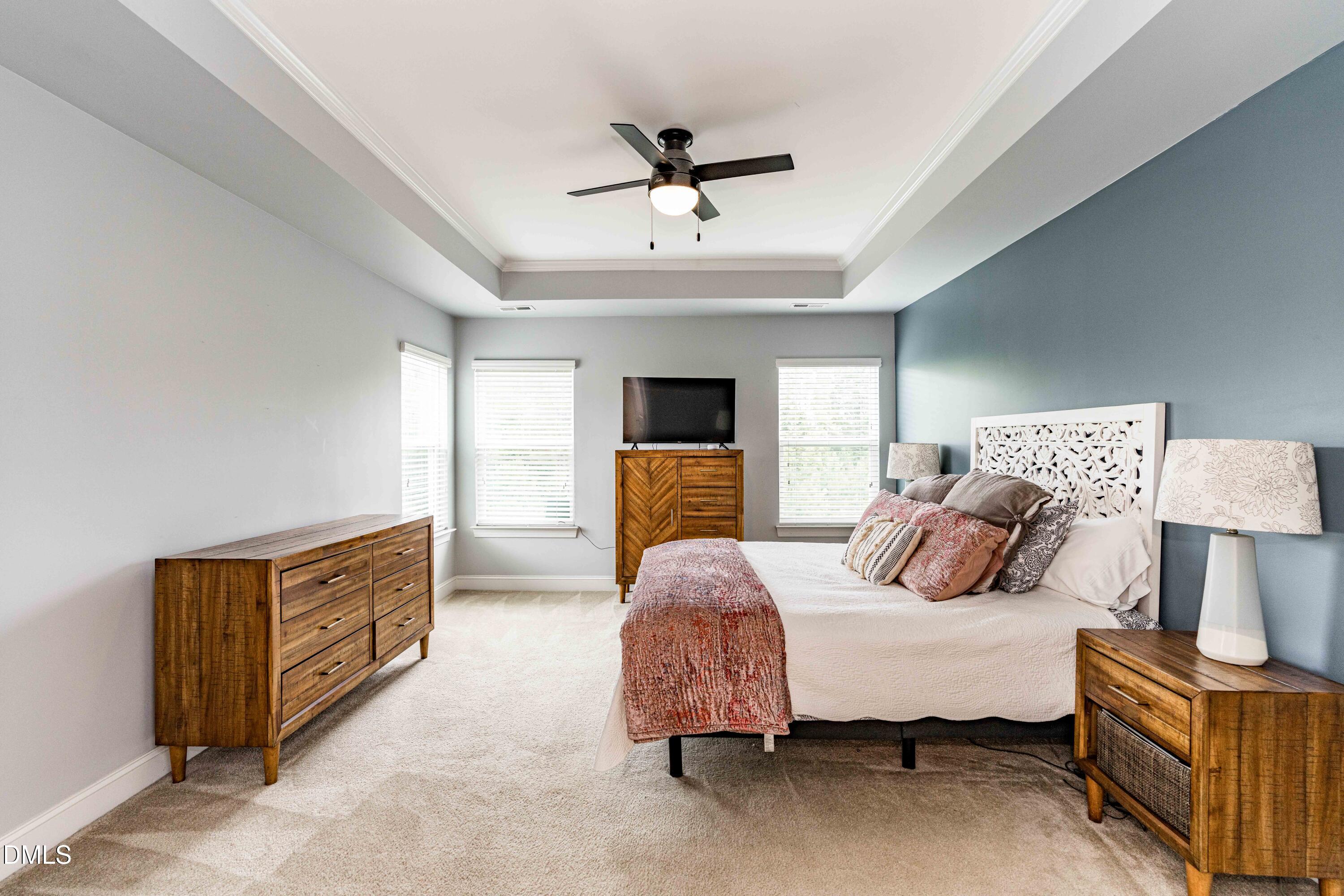 5405 Weathered Rock Court Knightdale, NC 27545 - Photo 26 of 36 a bedroom with a bed dresser and a window