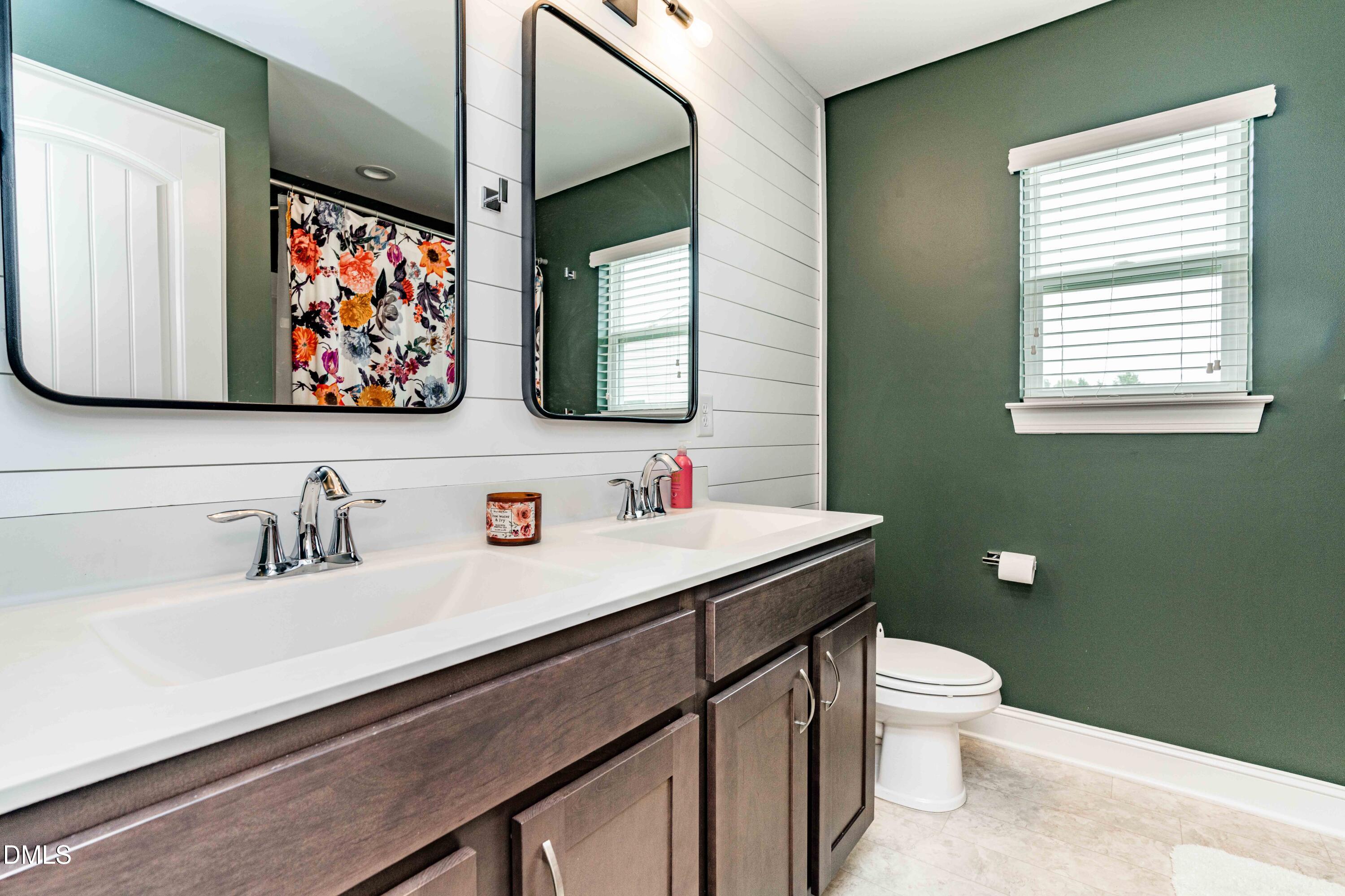 5405 Weathered Rock Court Knightdale, NC 27545 - Photo 29 of 36 a bathroom with a sink mirror and toilet