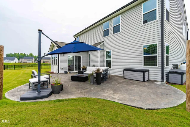 a view of a house with swimming pool and sitting area