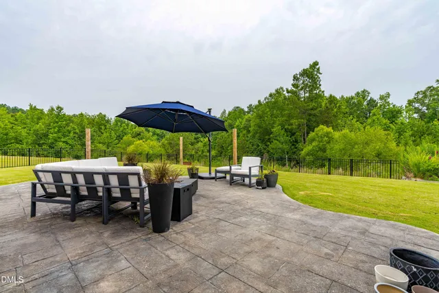 a view of a swimming pool and lounge chair in the patio