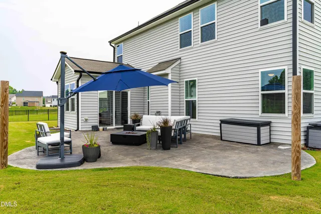 a view of a house with backyard and sitting area