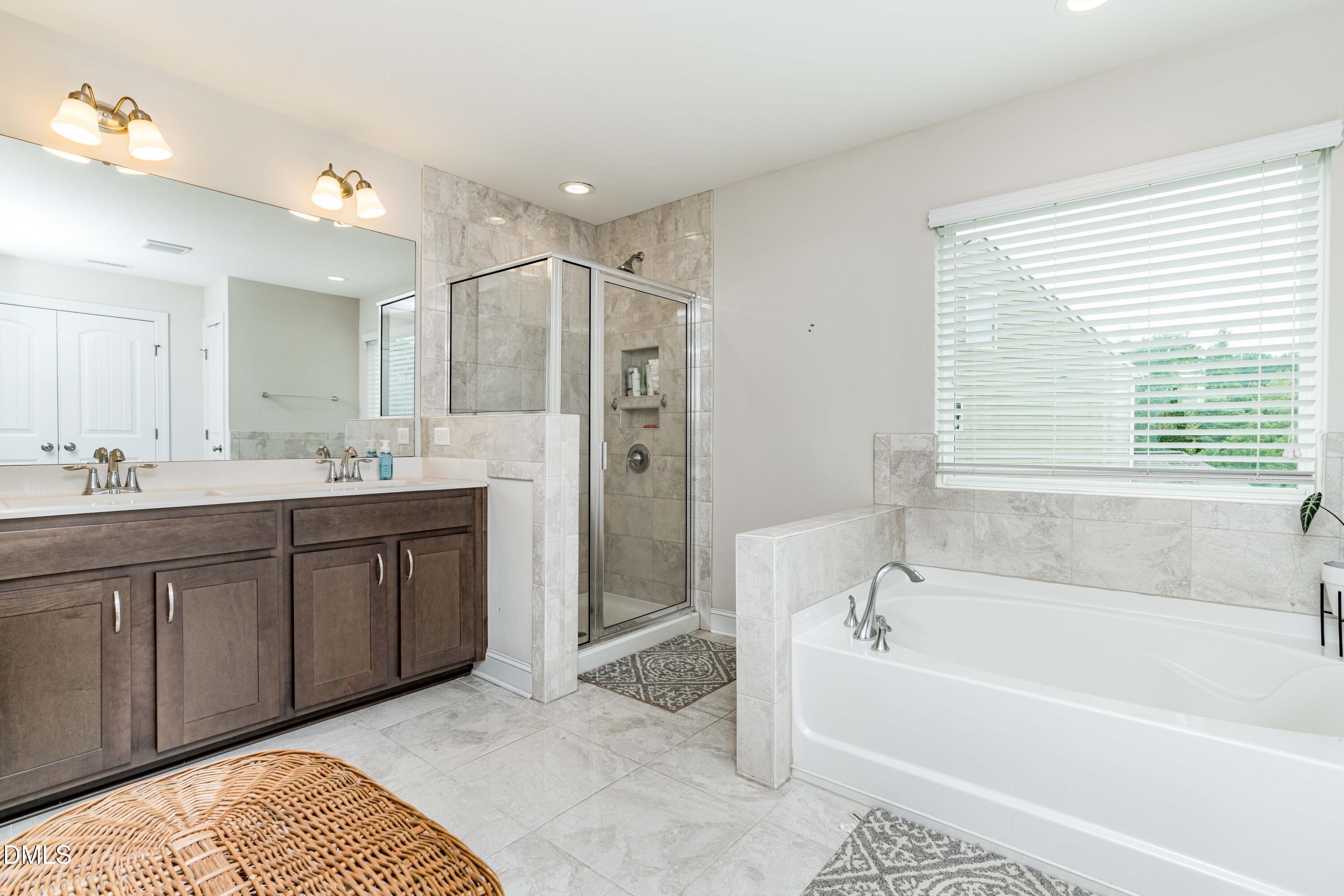 5405 Weathered Rock Court Knightdale, NC 27545 - Photo 36 of 36 a spacious bathroom with a tub sink shower and a mirror