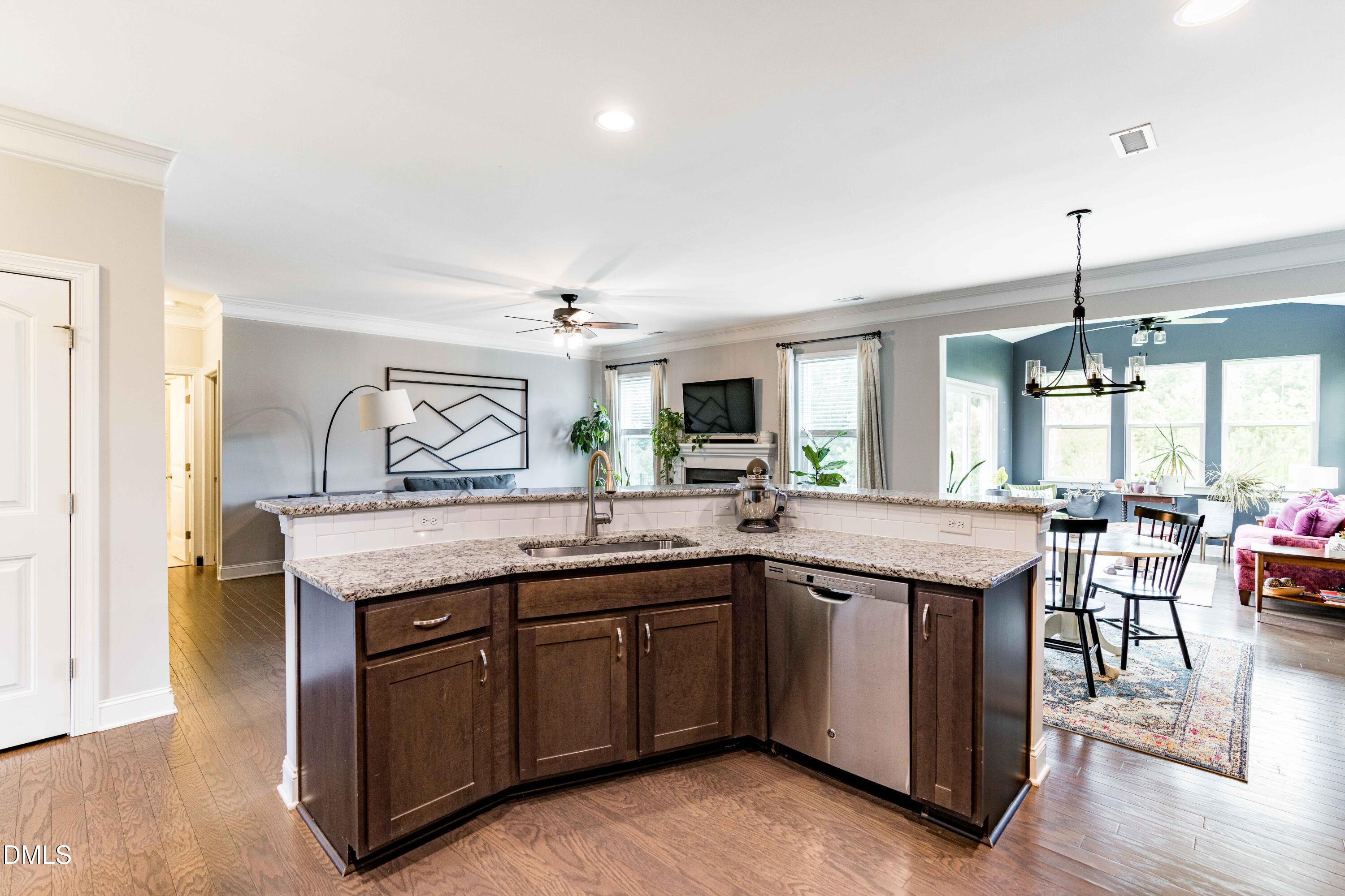 5405 Weathered Rock Court Knightdale, NC 27545 - Photo 8 of 36 a kitchen with granite countertop a sink and cabinets