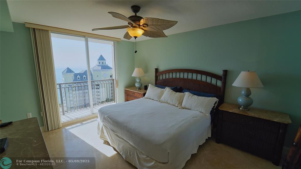2011 North Ocean Boulevard, Unit 1606 Fort Lauderdale, FL 33305 - Photo 15 of 30 a bedroom with a large bed and a chandelier