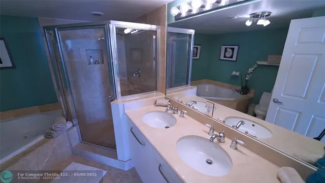 a bathroom with a double vanity sink and mirror