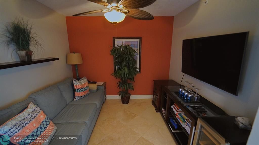 2011 North Ocean Boulevard, Unit 1606 Fort Lauderdale, FL 33305 - Photo 28 of 30 a living room with furniture and a flat screen tv