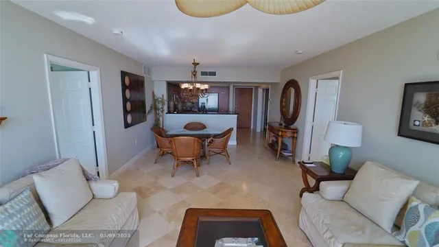 a living room with furniture a piano and a flat screen tv