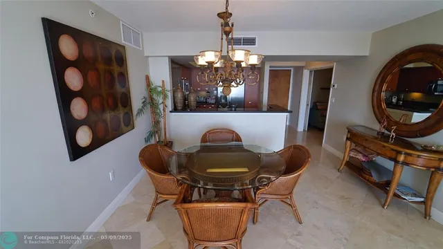 a dining room with furniture and chandelier
