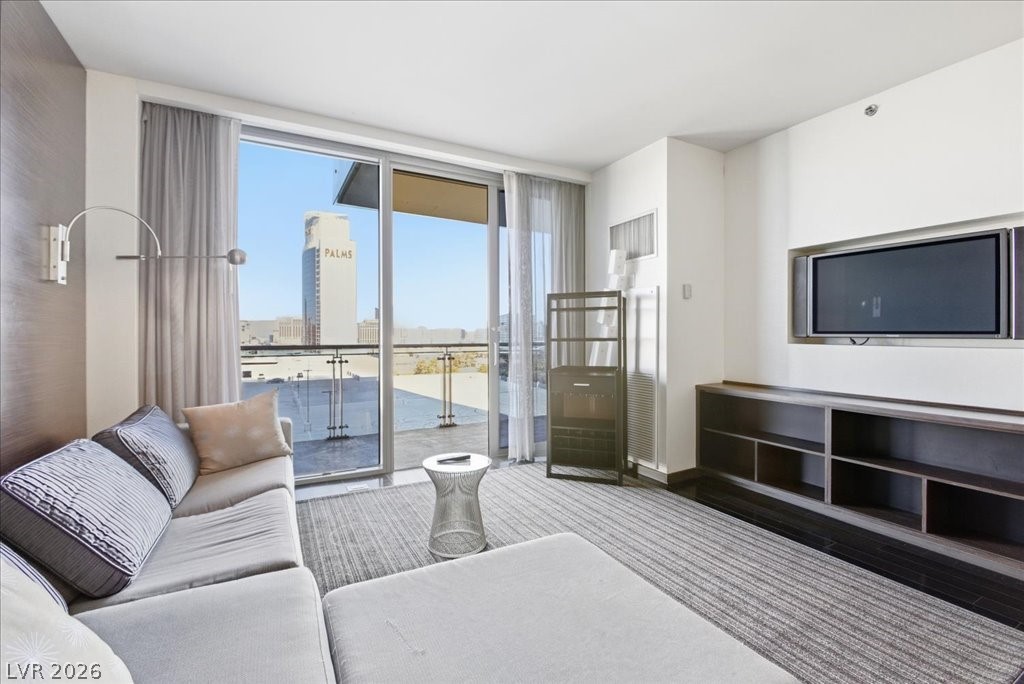 4381 West Flamingo Road, Unit 10306 Las Vegas, NV 89103 - Photo 12 of 26 This bright living space offers direct access to an outdoor balcony, ideal for relaxation.
