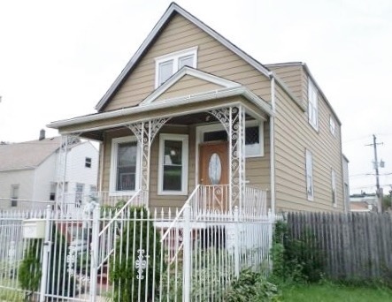 2210 North Keating Avenue Chicago, IL 60639 - Photo 1 of 10 a front view of a house with a garden