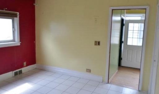 2210 North Keating Avenue Chicago, IL 60639 - Photo 4 of 10 a view of an empty room with window and bathroom