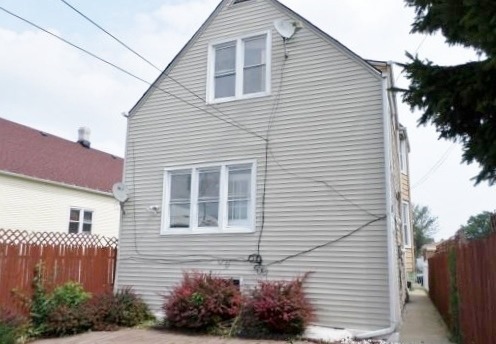 2210 North Keating Avenue Chicago, IL 60639 - Photo 9 of 10 a front view of a house with a yard