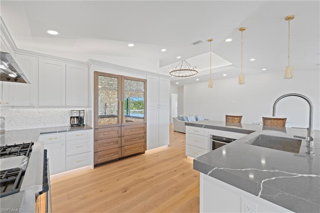 1836 Harbor Lane Naples, FL 34104 - Photo 11 of 40 a kitchen with a stove a sink and a refrigerator