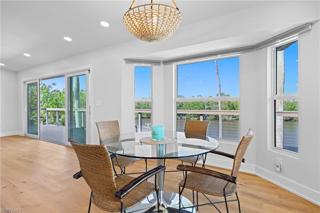 1836 Harbor Lane Naples, FL 34104 - Photo 12 of 40 a view of a dining room with furniture window and wooden floor