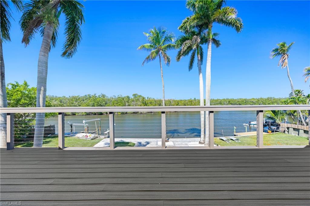 1836 Harbor Lane Naples, FL 34104 - Photo 14 of 40 a view of a lake with a table and chairs