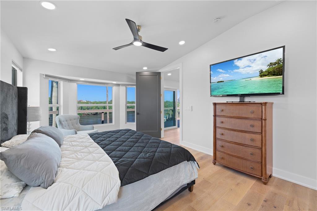 1836 Harbor Lane Naples, FL 34104 - Photo 17 of 40 a spacious bedroom with a bed and a flat screen tv