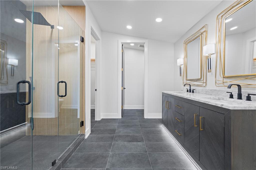 1836 Harbor Lane Naples, FL 34104 - Photo 18 of 40 a bathroom with a granite countertop sink a shower and a mirror