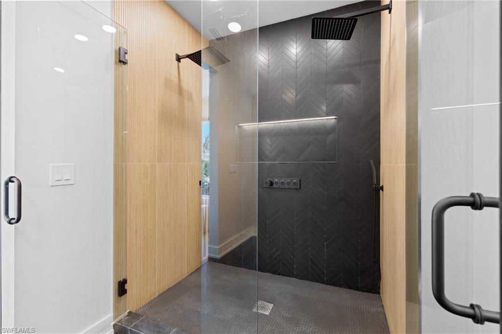 1836 Harbor Lane Naples, FL 34104 - Photo 19 of 40 a bathroom with a glass shower door