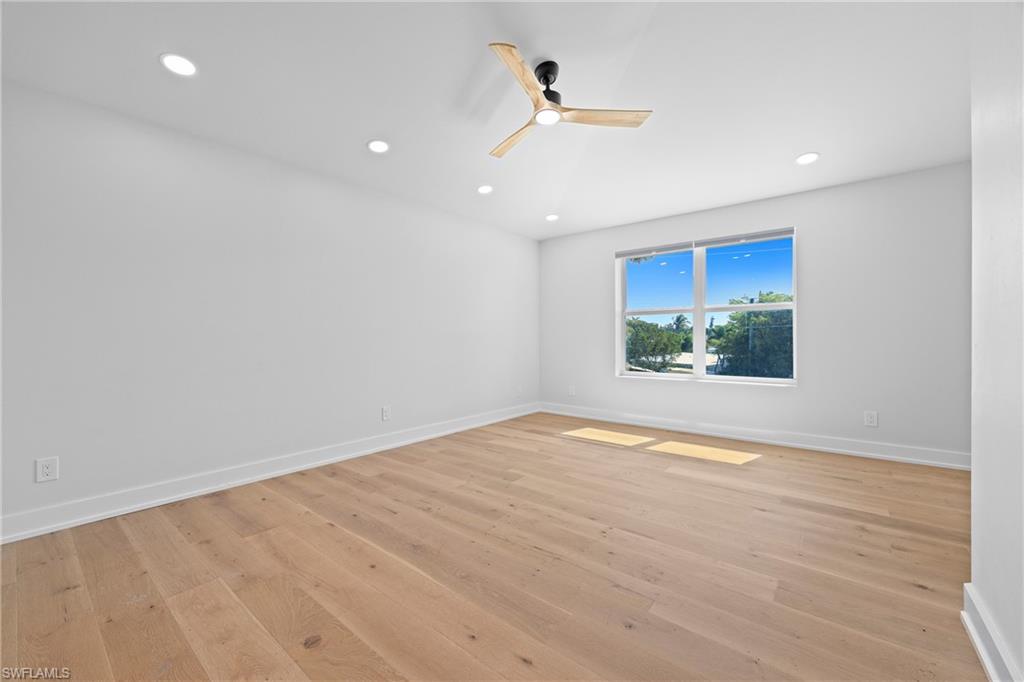 1836 Harbor Lane Naples, FL 34104 - Photo 20 of 40 a view of an empty room with wooden floor and a window