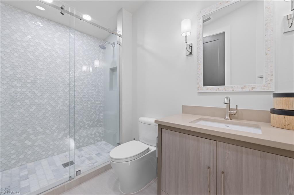 1836 Harbor Lane Naples, FL 34104 - Photo 23 of 40 a bathroom with a sink a toilet and shower