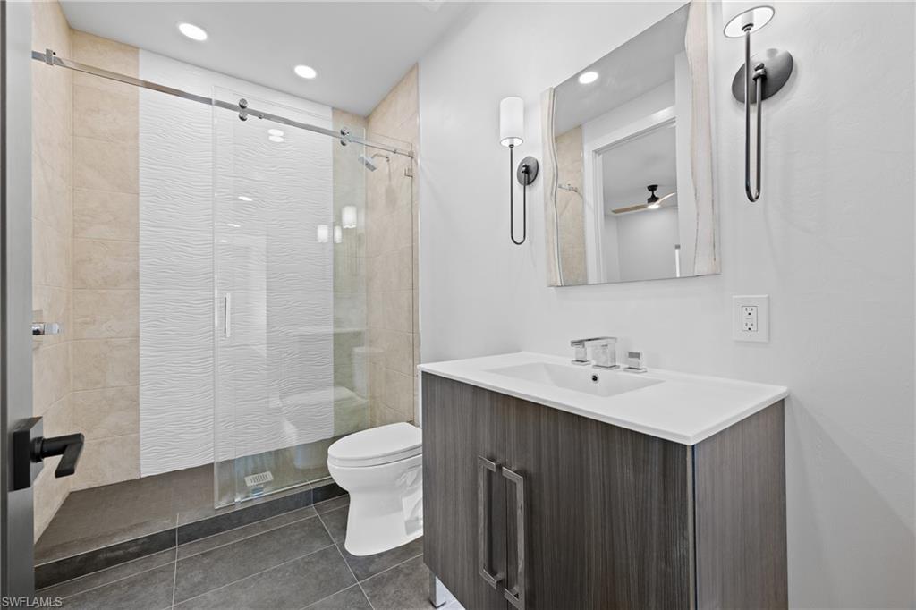 1836 Harbor Lane Naples, FL 34104 - Photo 25 of 40 a bathroom with a sink toilet double vanity and shower
