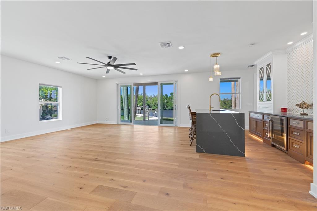 1836 Harbor Lane Naples, FL 34104 - Photo 27 of 40 a view of a living room a kitchen with furniture and wooden floor