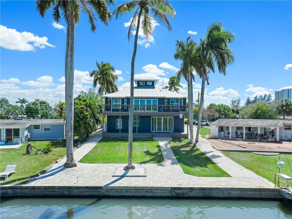 1836 Harbor Lane Naples, FL 34104 - Photo 39 of 40 a view of swimming pool with a table and chairs under an umbrella