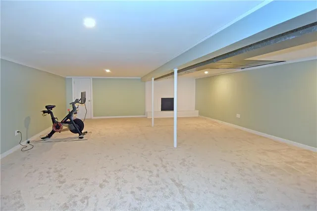 a view of a white house with a big yard and large tree