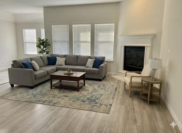 a living room with furniture and a fireplace