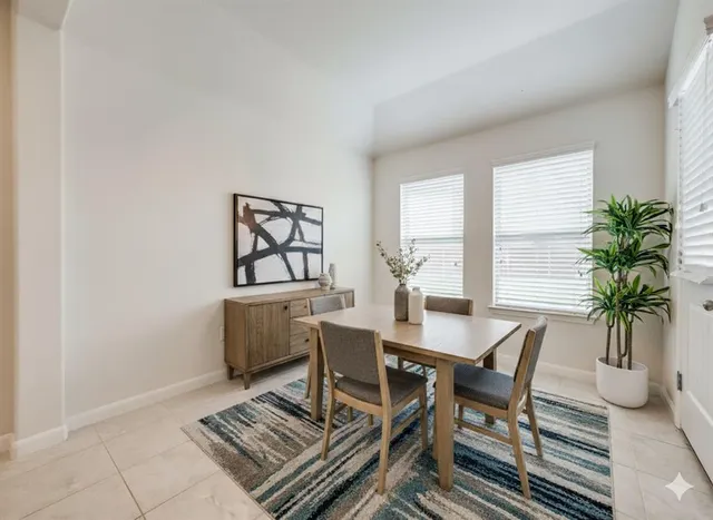 a dining room with furniture and window
