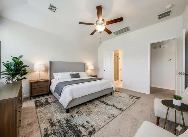 a bedroom with a bed and a potted plant