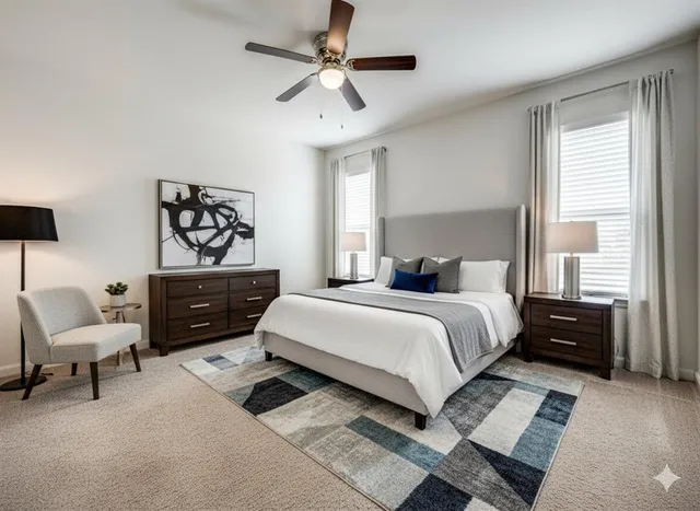 a bedroom with a bed dresser and a chair