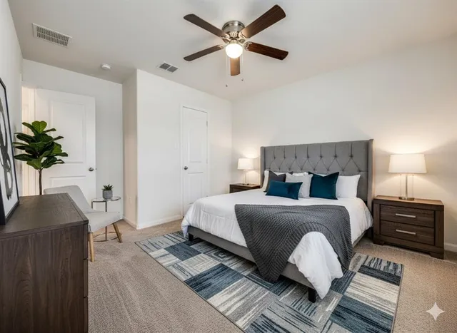a bedroom with a bed and a potted plant