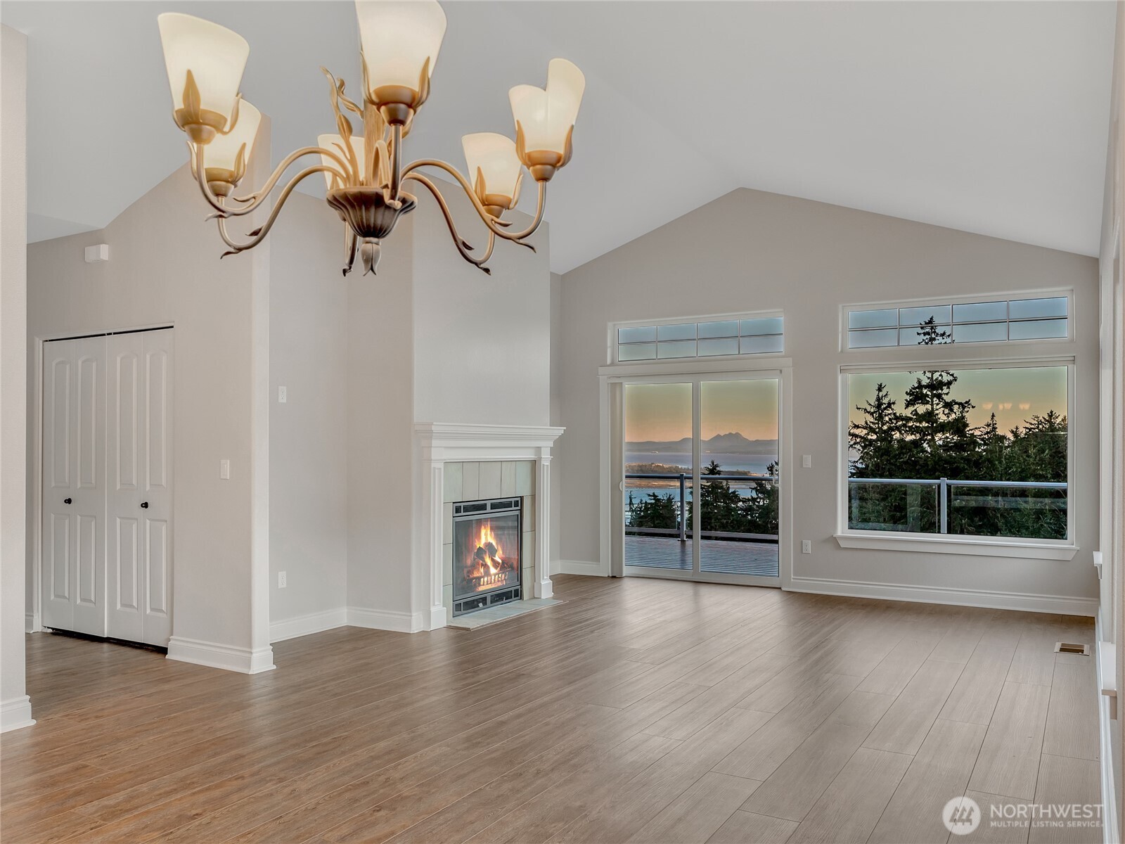 3224 Overlook Loop Ilwaco, WA 98624 - Photo 11 of 38 a view of a room with wooden floor fire place and windows