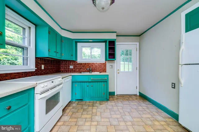 a kitchen with a sink cabinets and a window