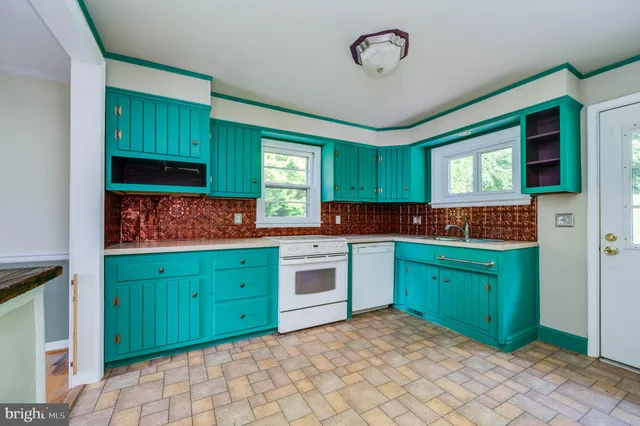 a kitchen with granite countertop cabinets and a stove top oven