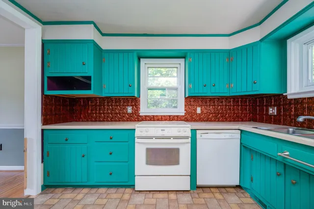 a kitchen with a sink cabinets and a microwave