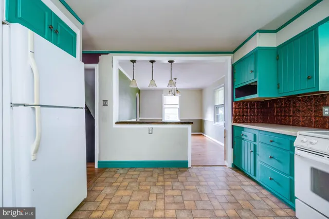 a kitchen with cabinets and a refrigerator