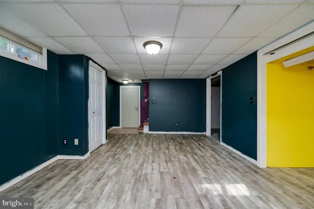 a view of hallway with a large window and chandelier