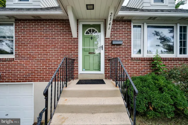 a view of a brick house with stairs