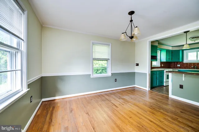 a view of room with window and wooden floor