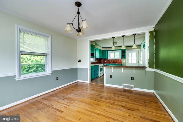 a view of a room with wooden floor and staircase