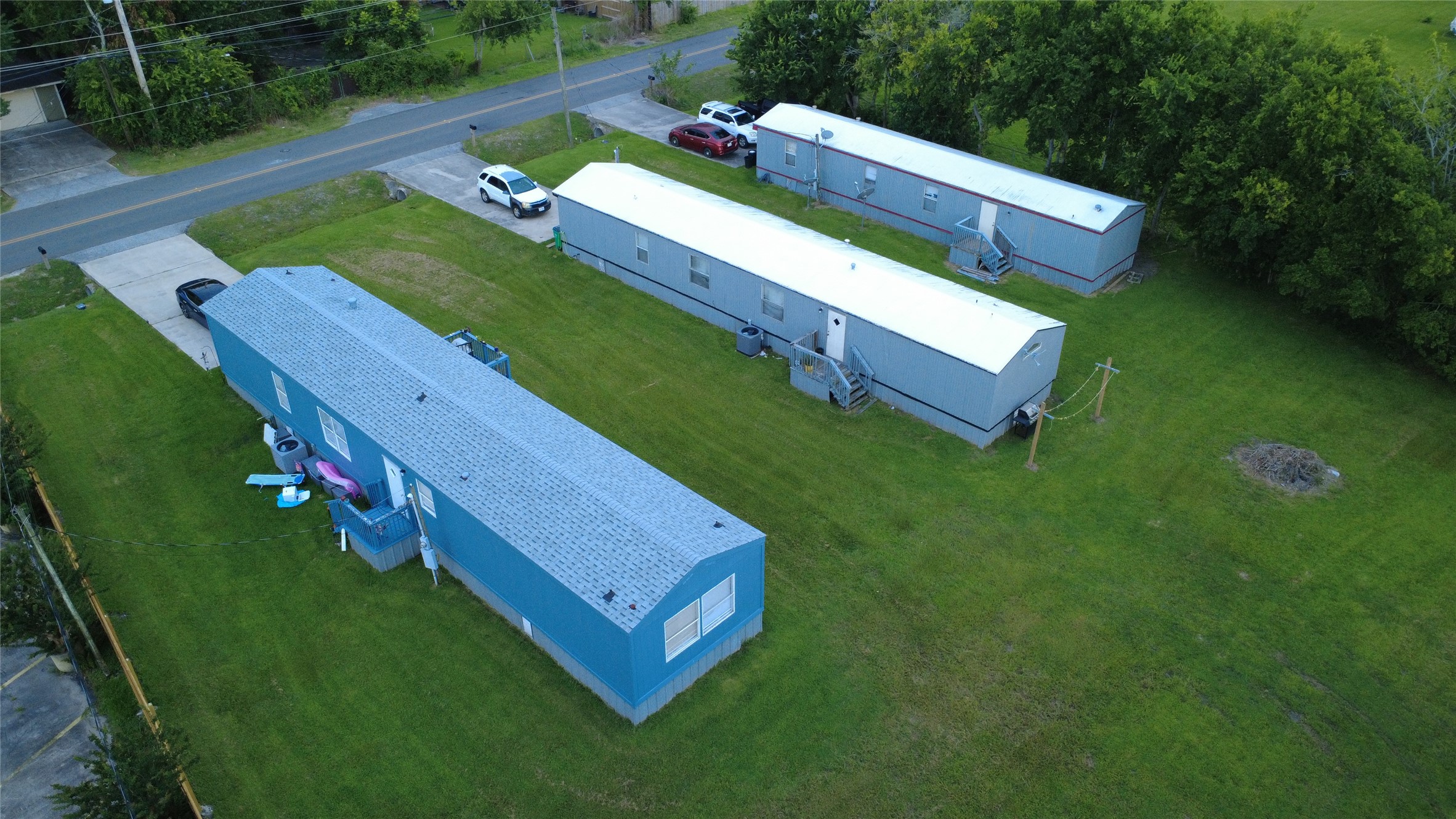 108 Bob Smith Road Baytown, TX 77521 - Photo 2 of 10 Elevated aerial view showcasing all three mobile homes and property layout.