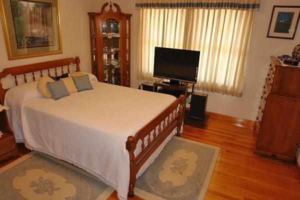 358 Blue Ridge Drive Blue Ridge, VA 24064 - Photo 14 of 22 a bed room with a bed and a flat tv screen on dresser